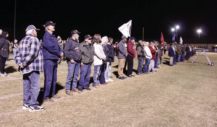 At least 30 veterans participated in the 'veteran's parade' where they were announced by Tecumseh High School Assistant Band Director Bailey Vaughn and stood on the THS football field to listen to their service theme songs. This was part of the Veteran's Day Light Show, coordinated by Band Director John Outon, who also invited the Meeker and North Rock Creek High School bands this year. Photos by Natasha Dunagan, Countywide &amp; Sun