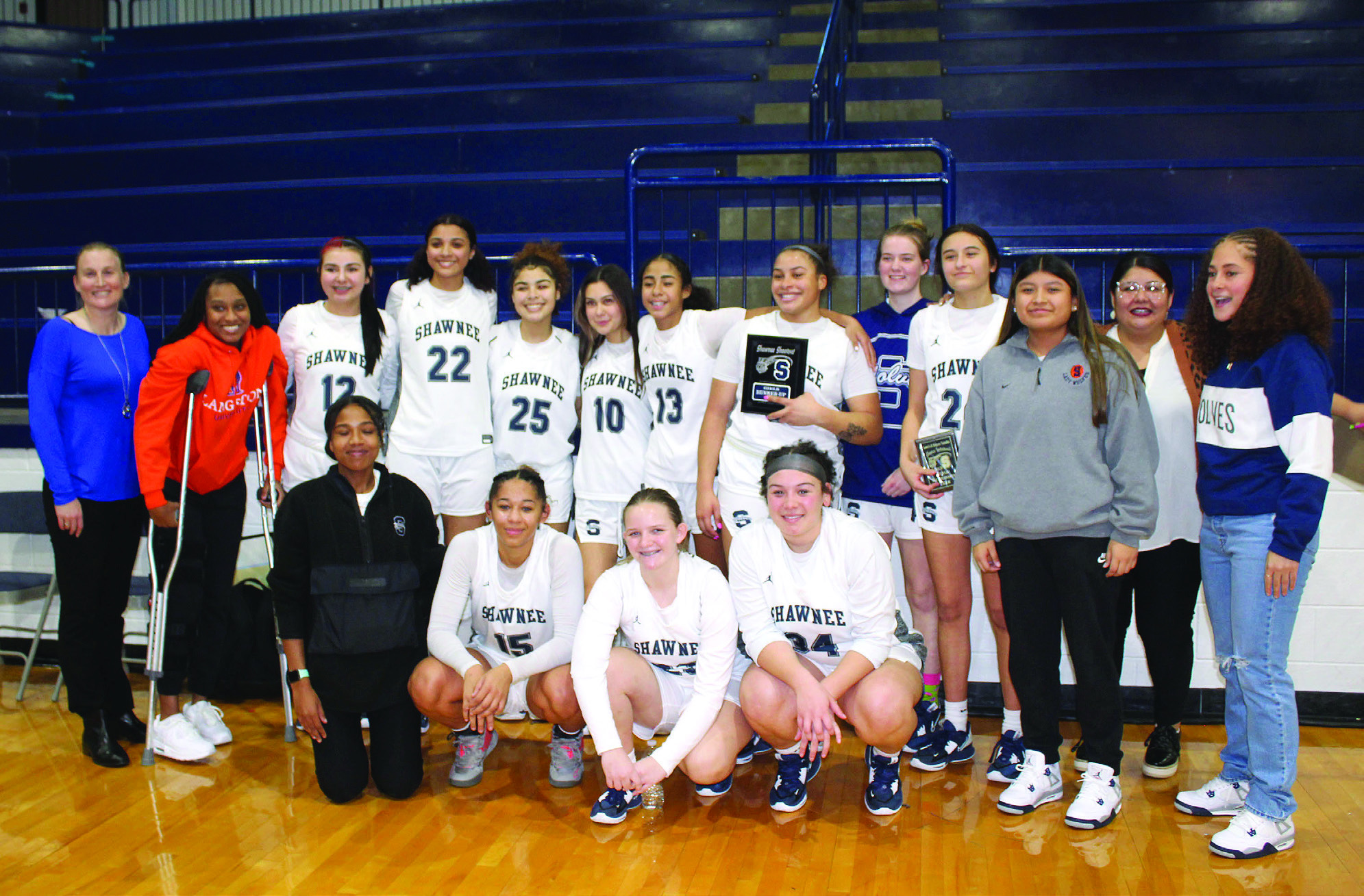 The Shawnee Lady Wolves, with their coaches and managers, pose after winning third place in the Lowe’s/Sehorn Yamaha Shawnee Invitational on Jan. 21. Daley Rice, fourth from right in back row, received All-Tournament. The tournament was held Jan. 19-21, and they won against McAlester, 56-48, lost with Jenks, 28-56, then beat Mustang, 28-25.