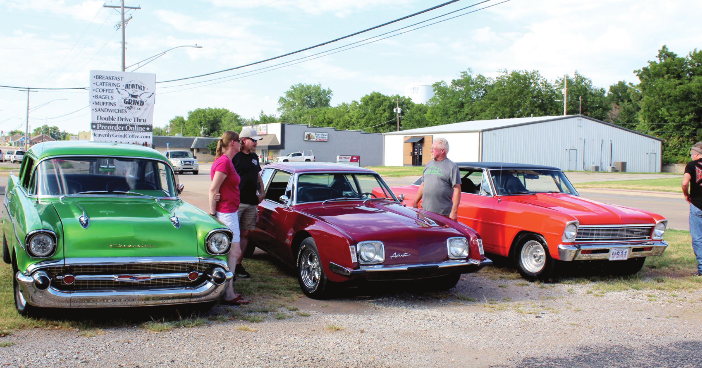 Danny Mellinger, of Tecumseh, third from left, talks with two visitors to the “Cruise the ‘Poo” event held on July 30 at the Brown Derby in Shawnee. Mellinger owns the 1964 Studebaker Avanti, in the middle. Also shown, left, is a 1950s Chevrolet owned by Sam Harden, of Tecumseh, and, right, a 1966 Chevy II owned by Andy Winkler, of Bethel. Mellinger said he was among the original “Kickapoo Riff Raff” who cruised Kickapoo and caused business owners to complain. 