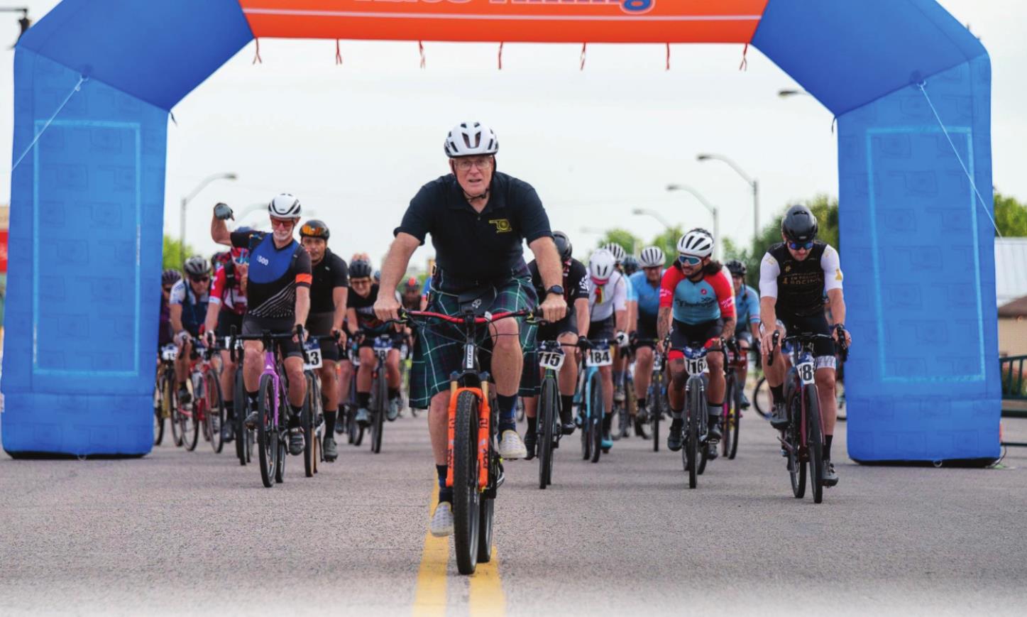 spOKeLAHOMA owner Craig MacIntyre (in the kilt) leads the racers out to start the Fenrir Unchained Bike Race in Tecumseh on June 4. MacIntyre said this was a good first year with 85-90 riders participating. Photo provided.