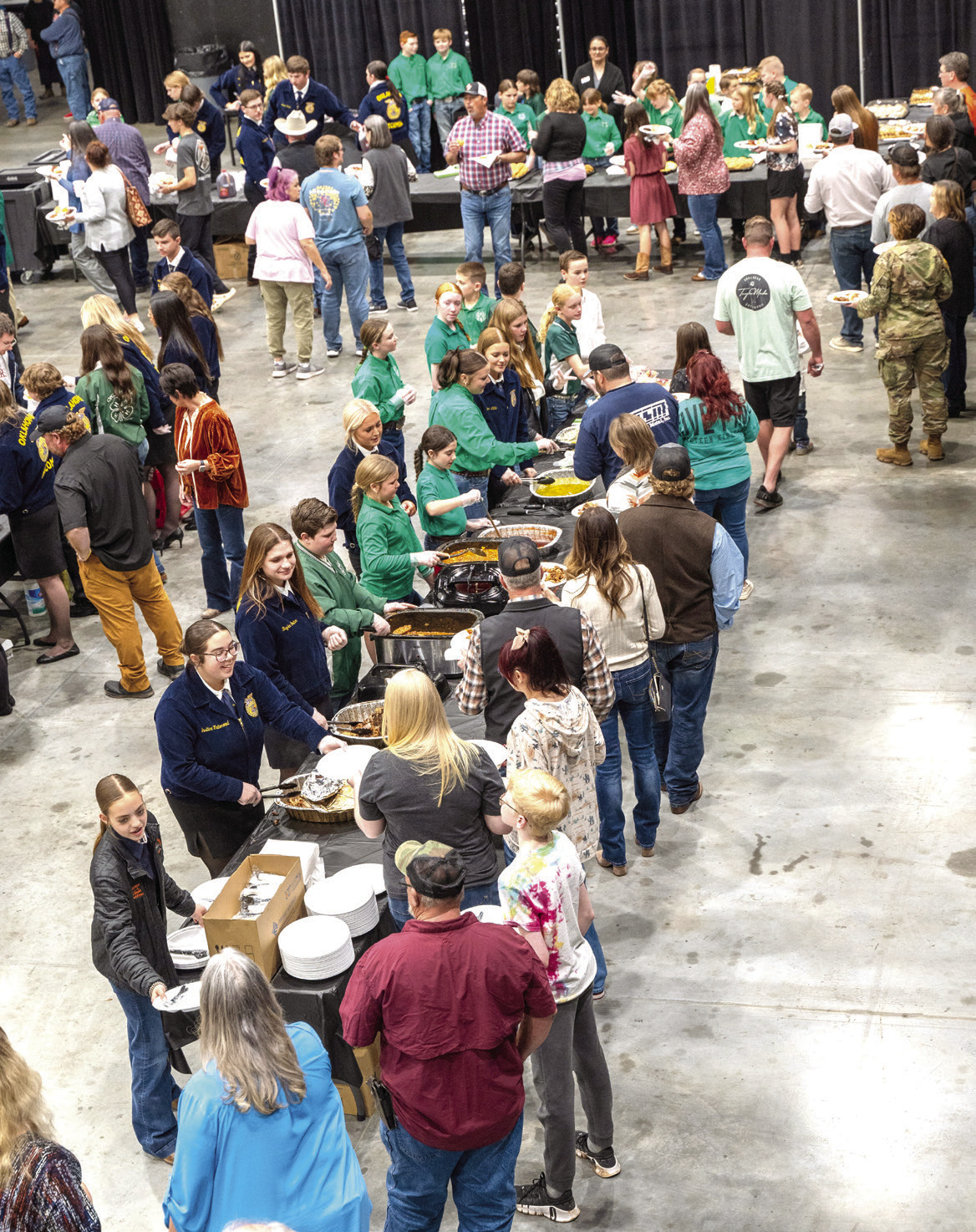 Attendees line up for the traditional PCJLS Trophy Auction dinner, served by 4-H and FFA members. Approximately 575 meals were served before the record breaking auction began. Photo provided