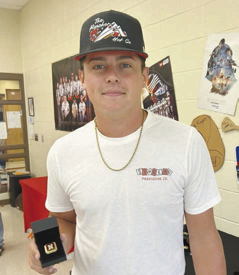 Right: Braden Ueltzen poses with his Archery State Championship ring. Ueltzen placed second in high school boys at the State Tournament but was unable to attend Nationals due to a conflict with NRC baseball state playoffs. He will be attending USAO in Chickasha this fall on a baseball scholarship. Photo Provided