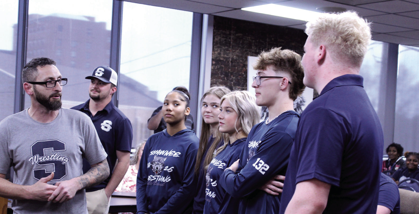 Shawnee Head Wrestling Coach Andrew McCune, far left, introduces the high school wrestling state qualifiers during the March 9 Shawnee Board of Education meeting. Shown from left are McCune, Assistant Coach Will Hilton, Ayanna Cruz, Claudia Thomason, Silver Belvin, Stetson Tucker and Logan Skelton. Not pictured are Booker Dahlman and Za’Karia McClain. Natasha Dunagan, Countywide &amp; Sun