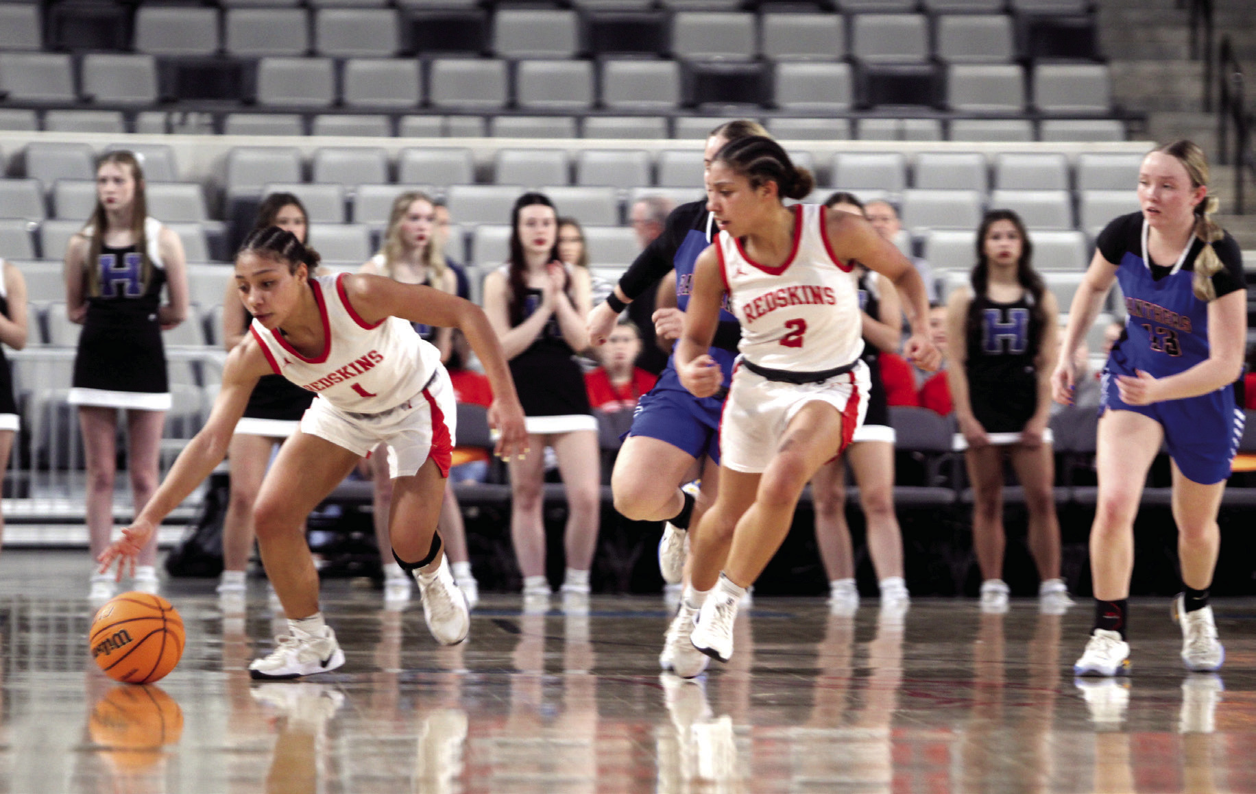McLoud juniors, twins Chloe and Claire Mapira, take the ball up court during the Class 4A State Quarterfinal game against Harrah, at the OG&E Coliseum in OKC on March 10. The Lady Redskins won, 44-30, and advance to the Semifinals today (March 12) at 6 pm in Yukon. If they win, they will move on to the Finals on Friday, March 13, at 7:45 pm, back at the Coliseum. This is the Lady Redskins first ever State playoff run. Photos by Natasha Dunagan, Countywide & Sun