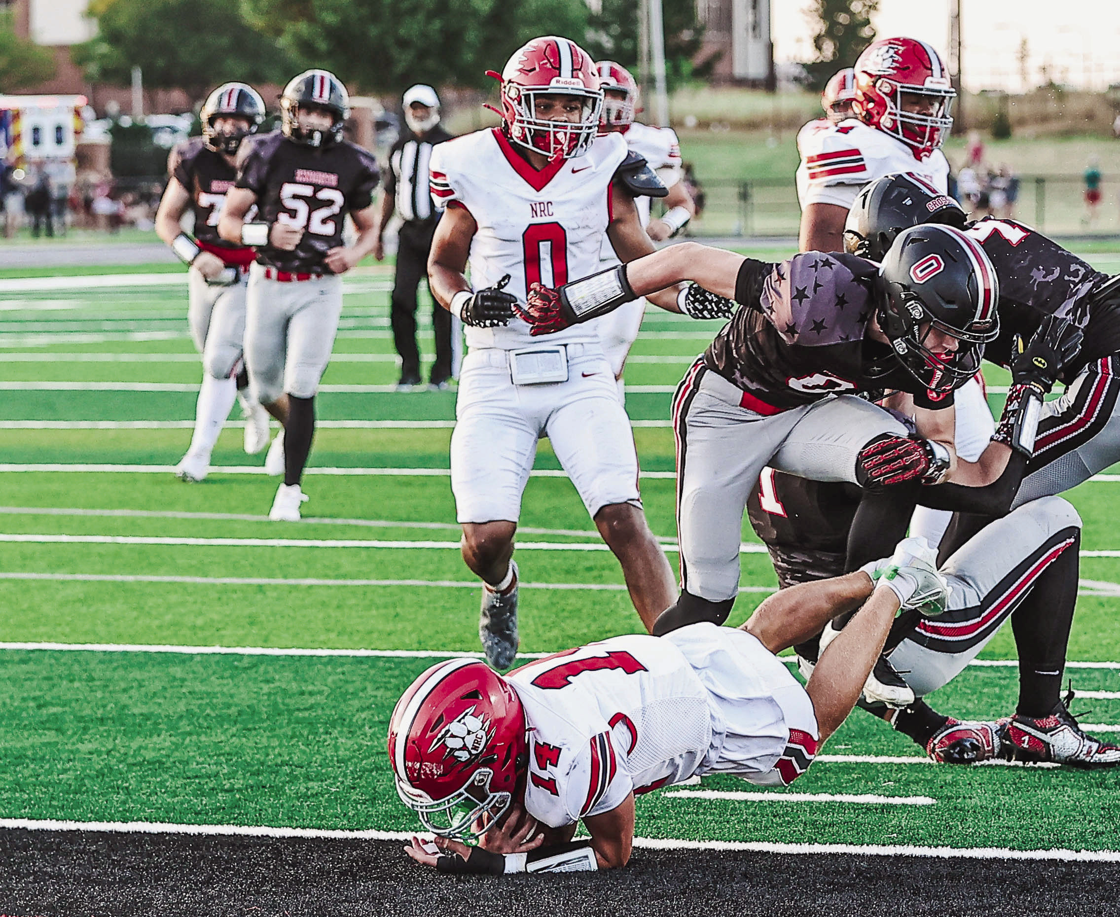 North Rock Creek's Cooper Standlee slips past three defenders to score a touchdown. The team got a 28-17 win over Crossings Christian Friday, Sept. 4. They will travel to Harrah tomorrow night. Photos courtesy of Gowin Photography