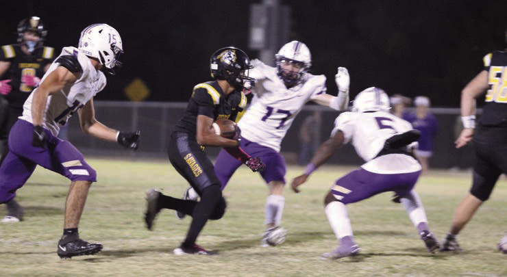 Tecumseh junior Jekhi Owens makes his way around a few Chickasha defenders during the district home game on Oct. 25. The Savages lost in overtime, 41-47. Countywide &amp; Sun/Natasha Dunagan