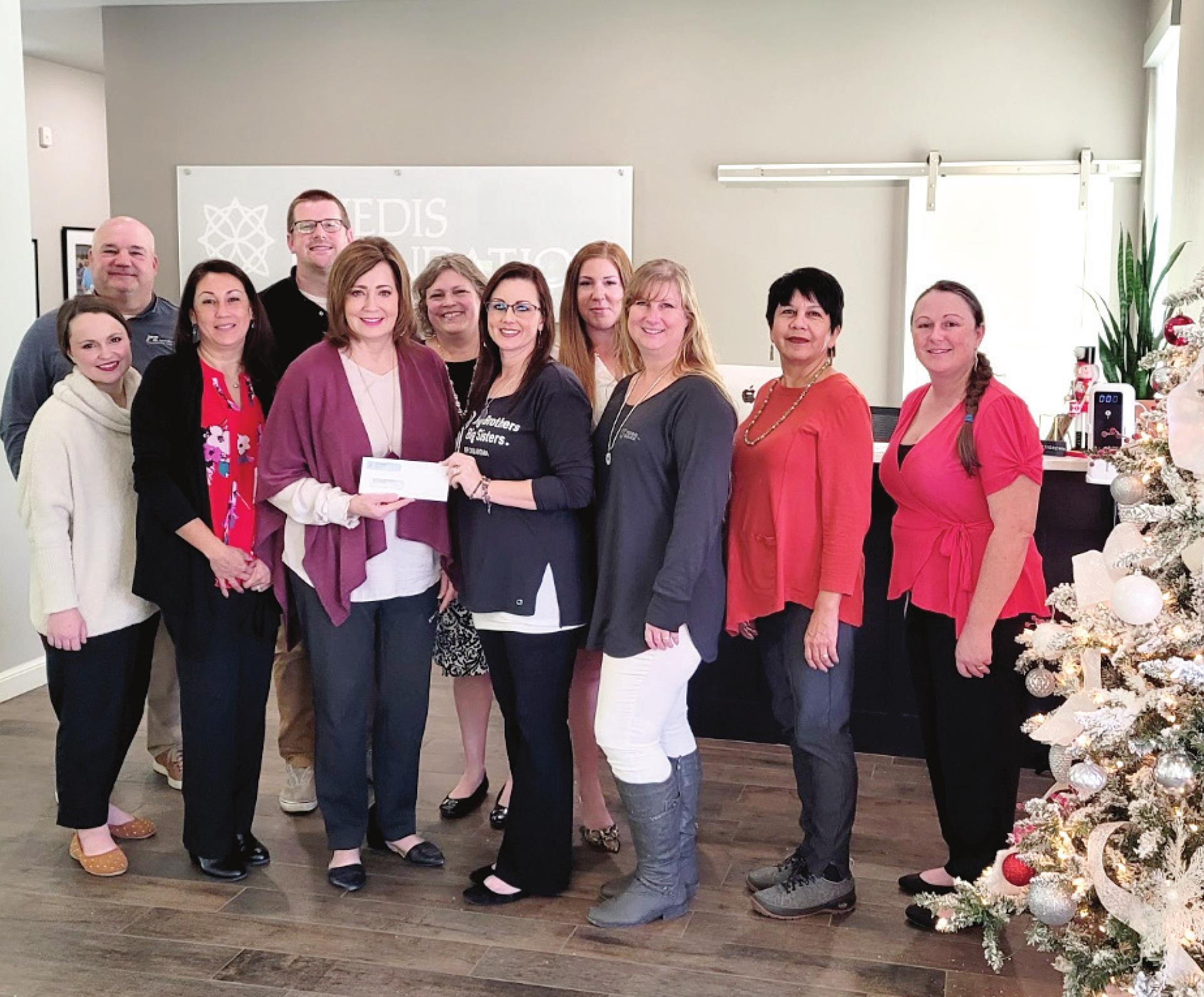 Kathy Laster, Ph.D. President and CEO Avedis Foundation presenting the grant check to Nikk Rieves, Shawnee Area Director joined by members of the Big Brothers Big Sisters Local Resource Board: Mary Belle Zook, Jeff Chamblin, Vivian Lozano-Stafford, Lane Howard, Jennifer Siestema, Lisa Watson &amp; Leslie Merritt and Avedis Staff Tracy Meeuwson &amp; Cheyenne Pettigrew. Photo provided