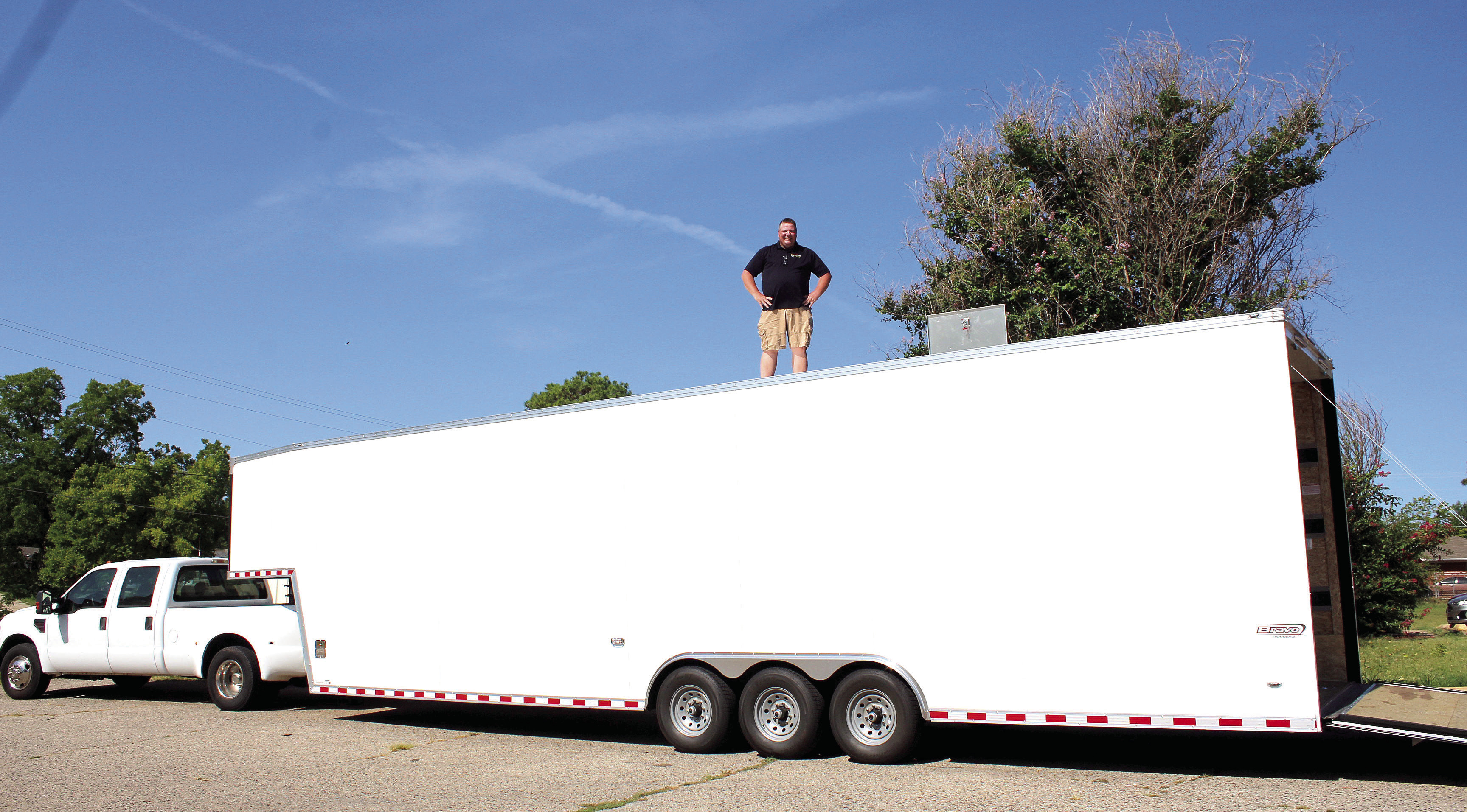 Tecumseh Band Director John Outon stands atop the band's new 9-foot tall, 40-foot long, enclosed gooseneck trailer on Aug. 3. Outon is thankful to everyone involved in approving the purchase of the trailer, which was paid for with the 1/2-cent Pottawatomie County sales tax. Countywide & Sun/Natasha Dunagan