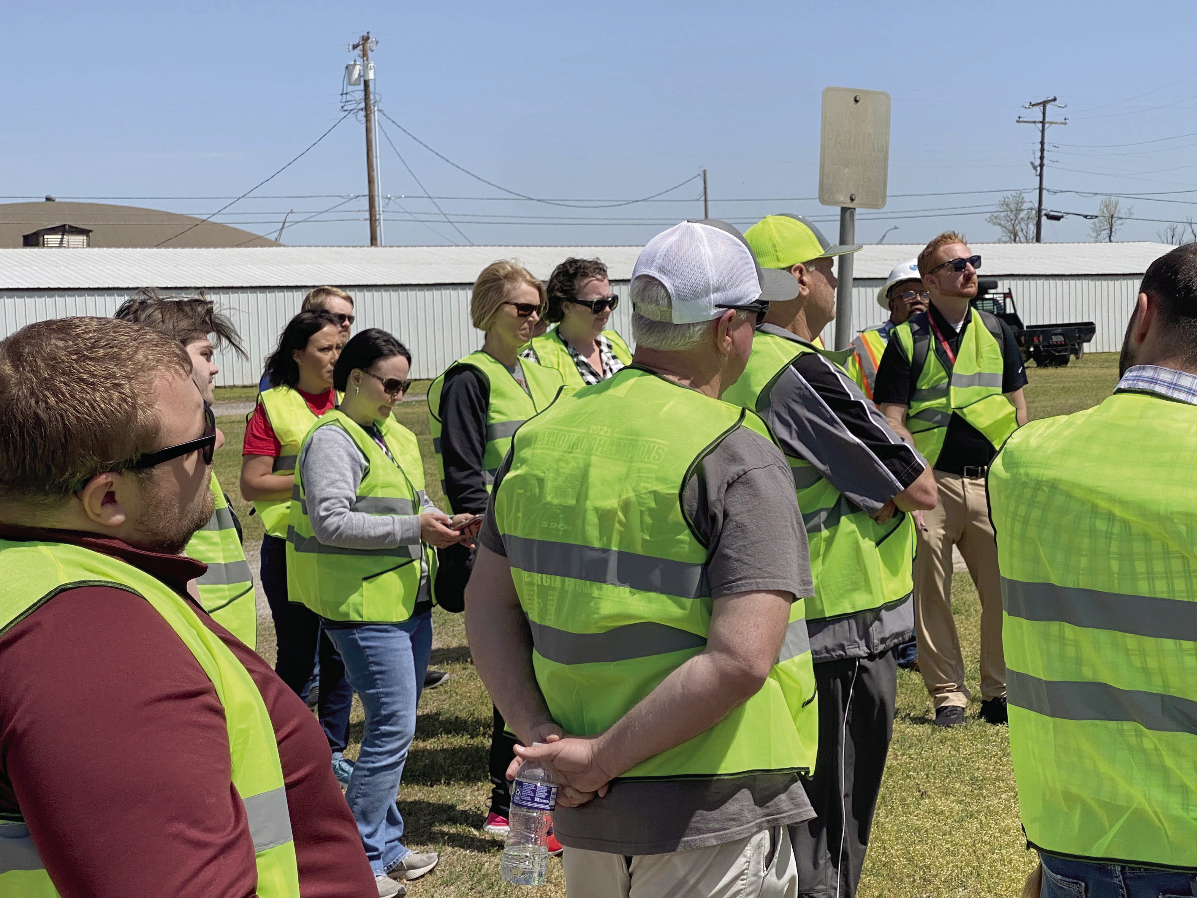 Participants of the Walking Audit in McLoud, held two days before the April tornado, stop to discuss things they have seen that could be changed or could be better. Photo provided