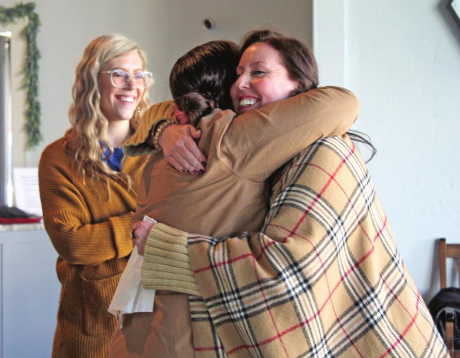 Nicole Sanchez and Renah Coffman have a hug after sharing their stories of loss, as Korie Perez looks on, during the Blue Zones Project Women’s Purpose Empowerment Brunch at Healthy Hive Nutrition in Shawnee on Feb. 12. Countywide &amp; Sun/Natasha Dunagan