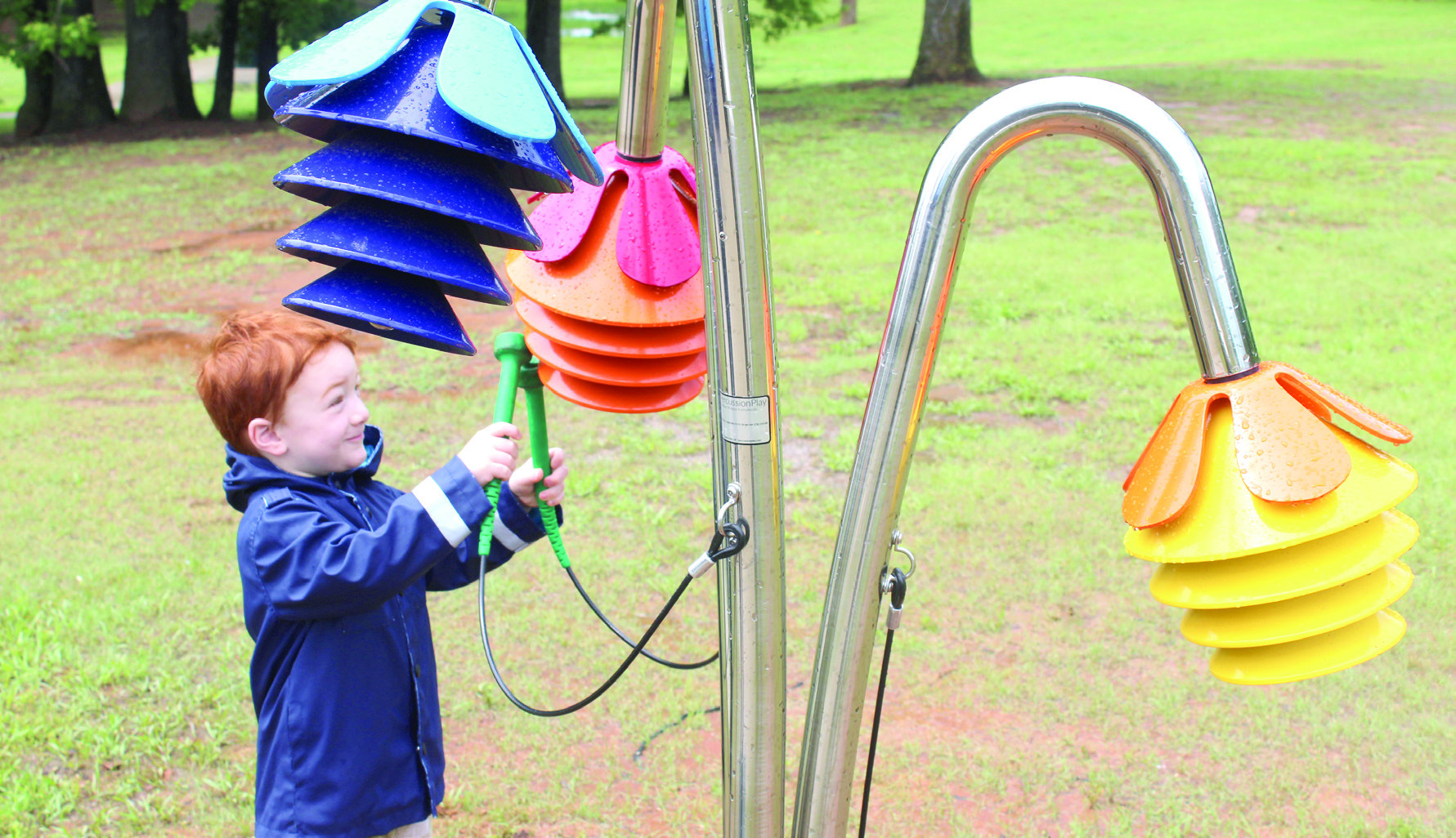 Frankie Lewis, 3, of Macomb plays the Rainbow Chimes on the Pioneer Library System Music Trail. Tecumseh Public Library had a ribbon cutting on April 25 for six new instruments, located along the northern trail of Slick Humphrey Park. Lewis's mother, Abigail Lewis, said her and her four children come to the park all the time. Natasha Dunagan, Countywide & Sun