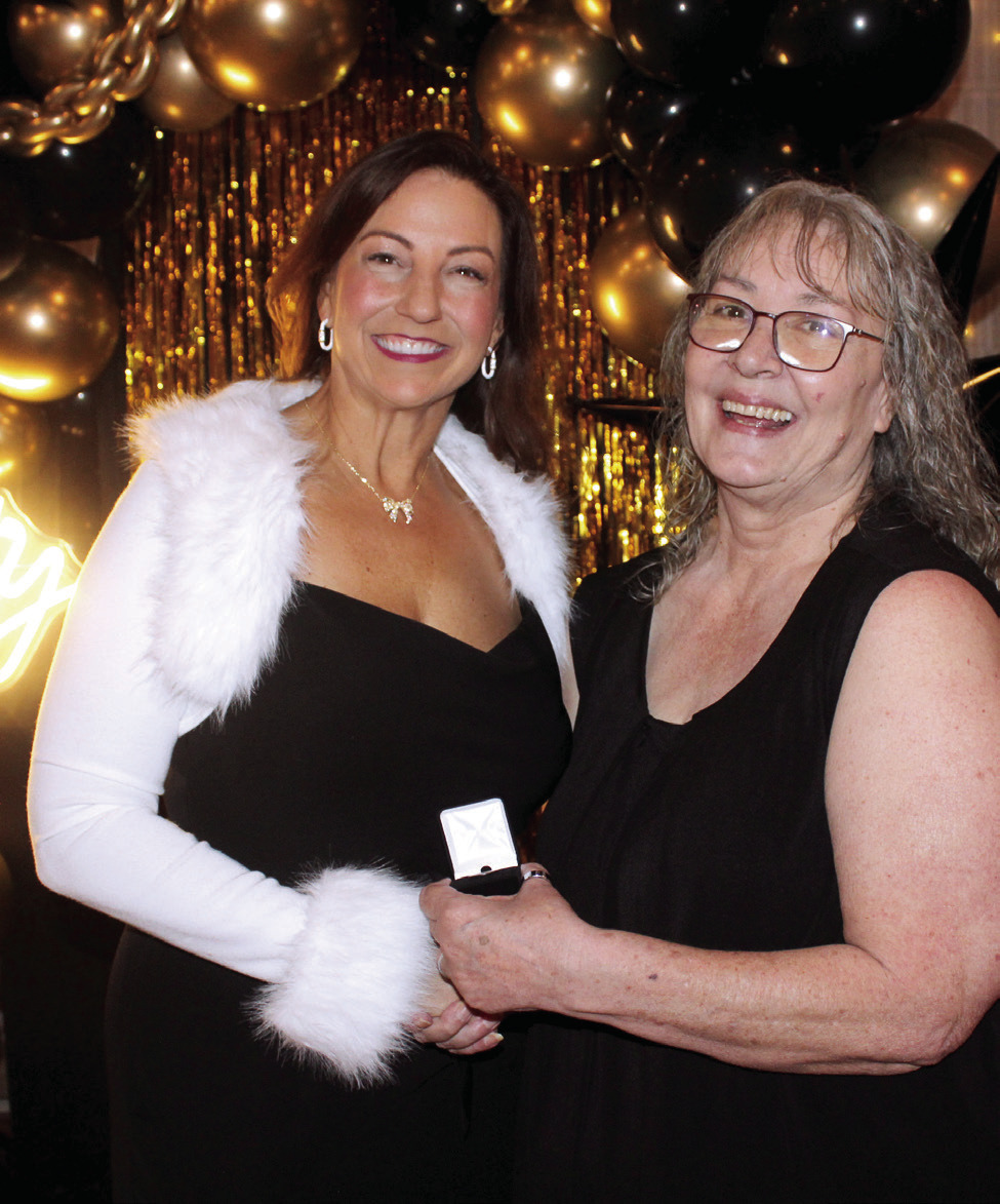 Rachael Melot, left, accepts a lapel pin from Countywide & Sun Publisher Suzie Campbell for placing eighth on the Pottawattomie Power Poll, during the Awards Gals on Oct. 24. Natasha Dunagan, Countywide &amp; Sun