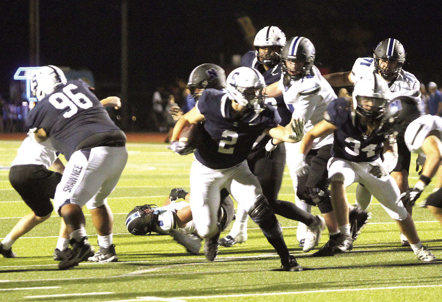 Shawnee junior Riley Storie blocks the Newcastle defense on his way to making a touchdown during the first half of the Sept. 25 homecoming game. The Wolves lost, 14-62. Natasha Dunagan, Countywide &amp; Sun