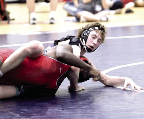 In the 132-weight class, Shawnee's Stetson Tucker works on flipping his Del City opponent for the pin during the home dual on Jan. 8. Overall, the Wolves won, 54-26, and the Lady Wolves won 34-28. Natasha Dunagan, Countywide &amp;amp; Sun