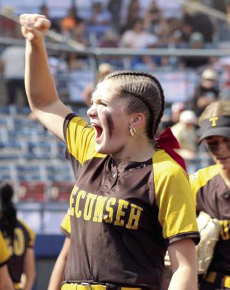Tecumseh junior Josie Walker rallies the fans, before descending into the dugout and going to bat, in the seventh inning of the Class 4A Fast Pitch State Quarterfinal game against Tuttle on Oct. 16.