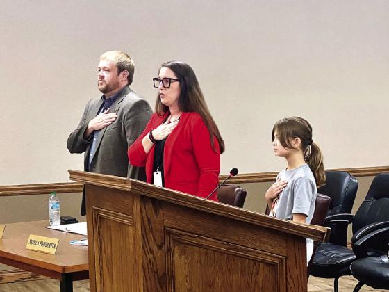 McLoud City Manager Cody Roe and Deputy Clerk Monica Poindexter recite the Pledge of Allegiance at the Aug. 28 McLoud City Council meeting. The pledge was led by special guest, 9-year-old Magnolia McClure (Mayor McClure's daughter). Julie Talton, Countywide &amp;amp; Sun