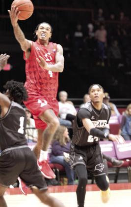 Potawatomi Fire Guard Chuck Guy takes the ball to the hoop in the second quarter of the March 14 home game against the Enid Outlaws at FireLake Arena. Guy was honored before the game this week for reaching 1,000 career assists, the first to do so in The Basketball League, and Deshawn Munson was recognized for making 1,000 career rebounds. Natasha Dunagan, Countywide &amp; Sun