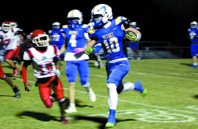 Bethel senior Luke Quinter makes his way to a touchdown during the Oct. 31 homecoming game, after escorting Homecoming Queen Lilly Jordan. The Wildcats won against Okmulgee 46-0.