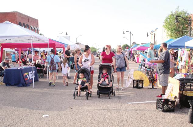 Event-goers browse through 87 vendor booths at the Mingle on Main Street Block Party, in Tecumseh, on June 16. Countywide &amp; Sun/Natasha Dunagan
