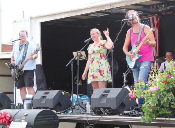 Midas 13 sings "I Gotta Feeling" by the Black-Eyed Peas during the Mingle on Main Street Block Party, in Tecumseh, on June 16. The cover band members, of OKC, are Aaron Daily, on bass; Amanda Martindale, on guitar; Ryan McMasters, on guitar; and James Wyrick, on drums. Daily, Martindale &amp; McMasters are also on vocals. Countywide &amp; Sun/Natasha Dunagan