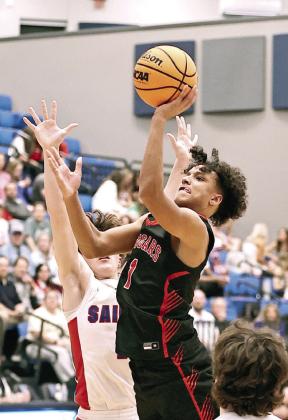 Pictured left, North Rock Creek's Kohen Warden puts up a 3 pointer. The Cougars beat Oklahoma Christian in the Area Championship 55-43. They are playing in the Big House for the third straight year. Pictured right, Memphis Burdine leaps through the defense for a two point shot. Photos courtesy of Gowin Photography