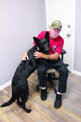 Kirk Bertolet of Bethel poses with his service dog Heidi on Oct. 27. Bertolet served as an electrician in the U.S. Air Force with the 1827 Electronic Installation Squadron. From 1979 to 1984, he traveled all over the world and learned from a couple of his superiors who took him under their wing. Natasha Dunagan, Countywide &amp;amp; Sun