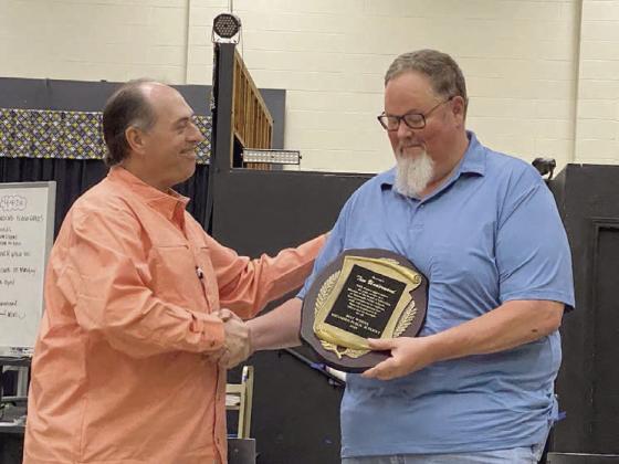 Tim Underwood accepts a plaque of appreciation from Tecumseh Board President, Todd Kennedy. Underwood’s seat remains vacant as the school board seeks candidate interest. Countywide &amp; Sun/Julie Talton