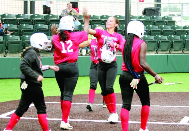 Earlsboro freshman Zory McGregor gets a high five from sophomore Lilly Gentry and other teammates after hitting a home run in the Macomb Fast Pitch Tournament game against LeFlore at FireLake Ball Fields on Aug. 29. This was the winning hit, as the Lady Wildcats won in Extra Innings, 6-5. Natasha Dunagan, Countywide &amp; Sun