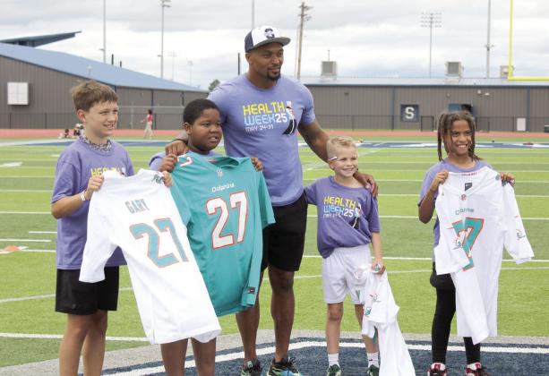 Former NFL safety Shamiel Gary gave away four Miami Dolphins jerseys to elementary students chosen by the Shawnee High School coaches during the first of two football clinics led by Gary on May 29 at Jim Thorpe Stadium. Natasha Dunagan, Countywide &amp;amp; Sun