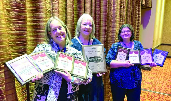 Julie Talton, Suzie Campbell, and Natasha Dunagan pose with the first-place awards and presidential plaque, received individually and for the paper.