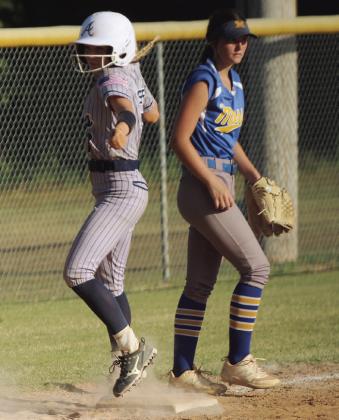 Asher junior Mackenzie Thompson jumps onto third base for the steal.