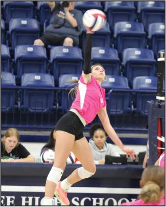 Shawnee’s Jordan Tash makes an attack during the home volleyball match with Guthrie on Pink Out Night, Oct. 1. The Lady Wolves won all three games. File photo