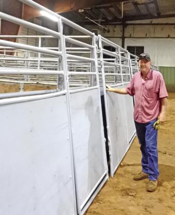 Mark Haynes inspects some of the refurbished panels after the painting is finished. File photo