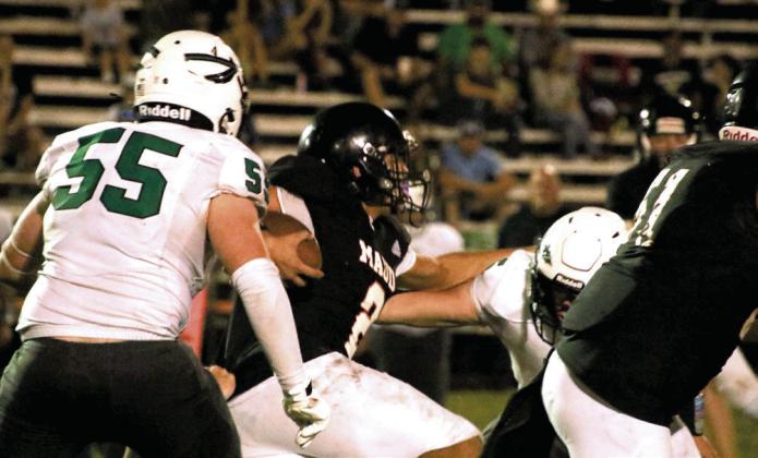 Maud freshman Jonathan Lamas is surrounded by Quinton Savages as he carries the ball during the home game on Sept. 19. Photo courtesy of Samantha Guinn