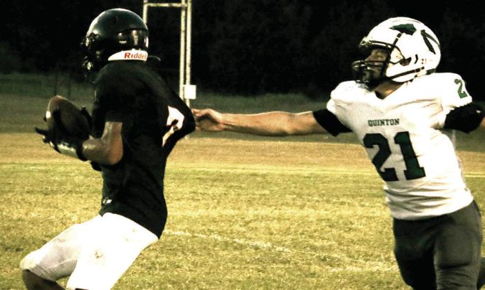 Maud freshman Koi Street tries to run the ball as a Quinton defender grabs his jersey. Photo courtesy of Samantha Guinn