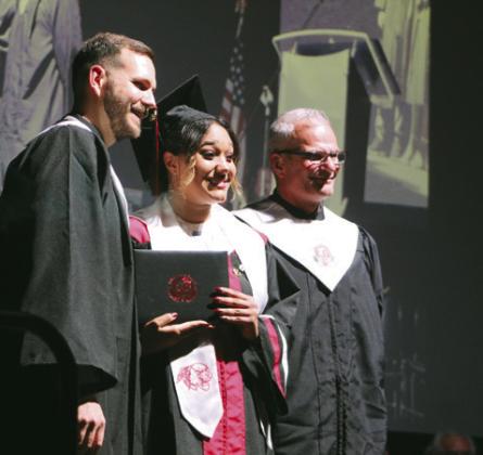 North Rock Creek graduate Symphony Green poses with her diploma and NRC Principals Justin MacDonald and Chad Brooking during graduation.