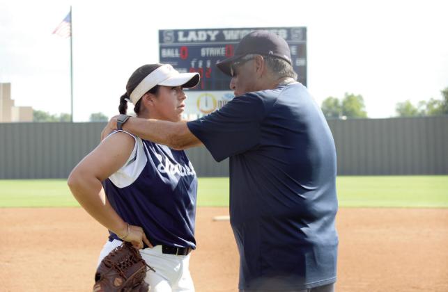 Shawnee's pitcher, Chochana Martin, consults with Coach Alex Flores during the home game against Putnam City North on Aug. 22. The Lady Wolves won, 7-5. Cheyanna Dietz, Countywide &amp;amp; Sun