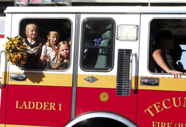 Children ride in a Tecumseh Fire Engine during the Frontier Days Parade on Sept. 30, 2023. File photo