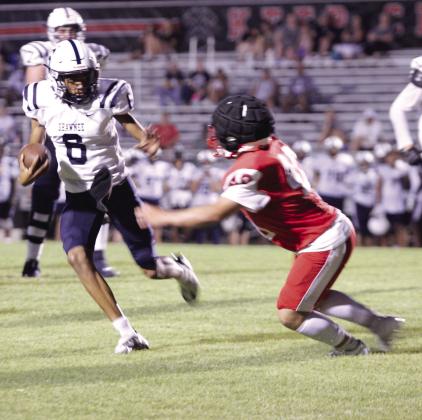 Shawnee junior Zyron Campbell deflects a McLoud defender for a first down and 20, but a call of holding made the Wolves lose yardage during the scrimmage at McLoud on Aug. 29. They played half a game, and the Redskins beat the Wolves, 19-14. Shawnee will play their first home game on Sept. 13 at 7 pm against Ardmore, and McLoud’s first home game will be Friday (Sept. 6) at 7 pm versus Harrah. Countywide &amp; Sun/Natasha Dunagan