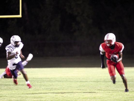 McLoud junior Zaylun Matlock catches a pass and runs up his home sidelines during the scrimmage at McLoud.
