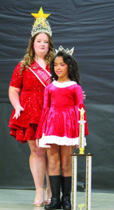 The 2021 Overall Christmas Miss A.J. Jenkins crowns 2022 Overall Christmas Miss Michelle Moore, of Shawnee, during the Christmas Miss &amp;amp; Mister Pageant on Dec. 3 at Will Rogers Elementary in Shawnee. Moore had the most points out of the 25 contestants in the pageant.