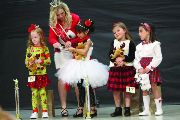 Preston Neely, 6, of Shawnee, is crowned for a second time as Most Beautiful and Christmas Fashion Queen in the 5-6-year division of the Christmas Miss &amp;amp; Mister Pageant on Dec. 3. Also shown are Oakley Garner, Delaney Chamblis, and Addison Jeffcoat. Countywide &amp;amp; Sun/ Natasha Dunagan