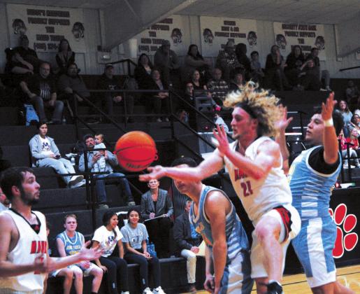 Above, Dylan Armstrong (#21) sets up his teammate Rodney Ray (#23) for a basket during Maud’s 62-47 win over New Lima, Feb. 8. Below, Lady Tigers’ Janlee impson (#13) leaps into the air in preparation to nail a two-pointer during Maud’s Feb. 8 home game versus New Lima. Countywide &amp;amp; Sun/Kendra Johnson