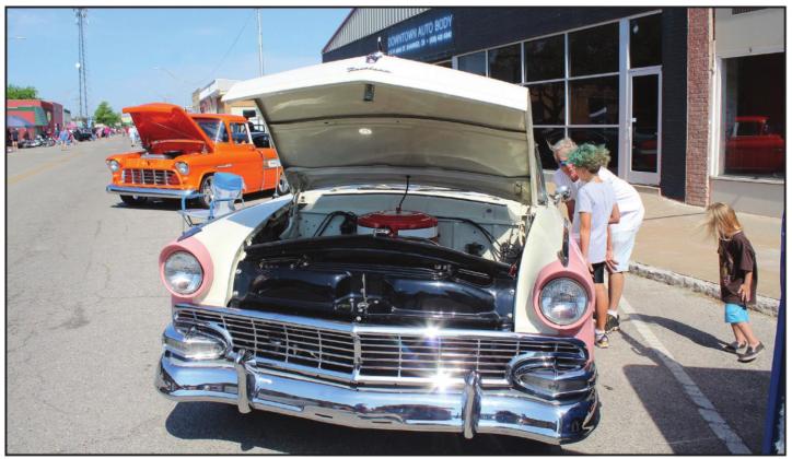 Russell Plotner, of Shawnee, talks with his son Padin Plotner, 9, about a 1956 Crown Victoria owned by Cheryl Spears, of Norman, during the City of 5 Nations Downtown Auto Show &amp; Shine on Main Street in Shawnee on July 16. Countywide &amp; Sun/Natasha Dunagan