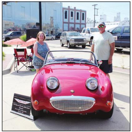 Sherry and Allen Tyler, of Sapulpa, pose by their 1959 Austin Healey MK1 Sprite, after lowering the hood to show its "smile," during the City of 5 Nations Downtown Auto Show &amp; Shine in downtown Shawnee on July 16.  Allen said Sherry's sister bought the "Bugeye" brand new when she was 20, and they have owned it for two years. Countywide &amp; Sun/Natasha Dunagan