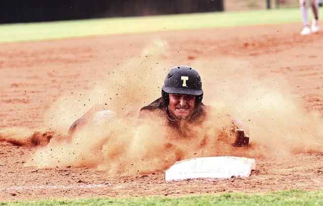 Tecumseh’s Caleb Sparks slides into third for his first triple.
