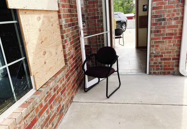 Joseph Armenta gripped the metal handle of the glass entry to Farmers Insurance on the corner of Federal and Kickapoo, while the April 19 tornado continued its path of destruction in Shawnee. Photo provided by Armento.