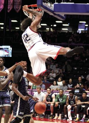 Potawatomi Fire Center Johnny McCants makes a slam dunk in the first quarter of the second game of The Basketball League Finals against the Tri-City Tide.