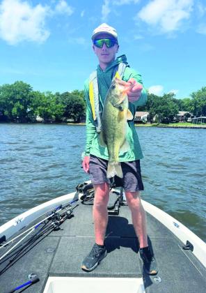Riley Motrych holds one of the largemouth bass he caught on Grand Lake during the Championship weekend.