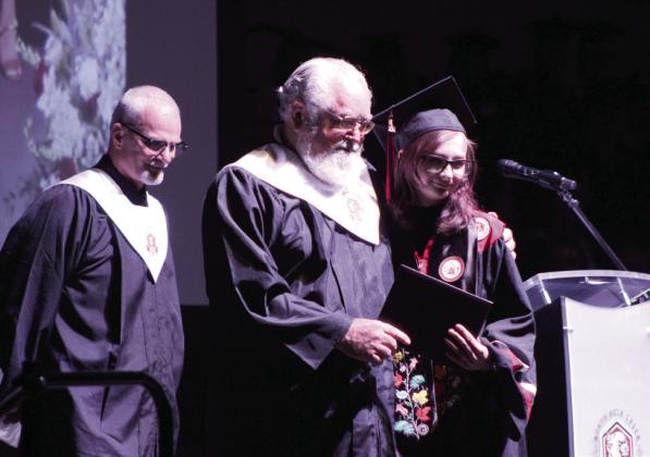 Aaliyah Coffman receives her diploma from her father, North Rock Creek Board of Education Member Brian Blansett, during graduation on May 22. NRC High School graduated 112 seniors. Natasha Dunagan, Countywide &amp;amp; Sun
